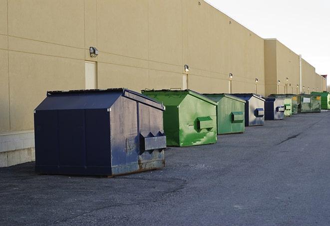 a fleet of red and blue construction dumpsters available for use in Lansford